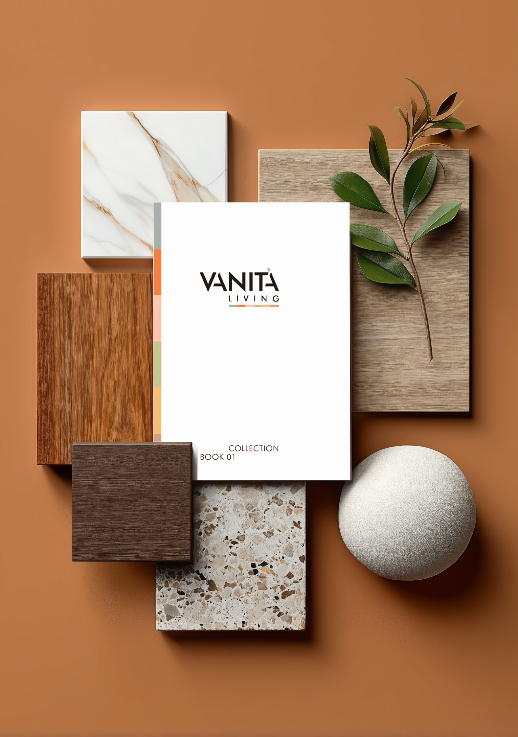 Catalogo Vanità Living appoggiato su una composizione verticale di campioni materici, legni, pietra e foglie su fondo terracotta.